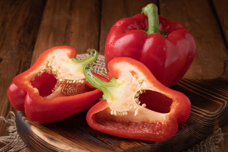 Eco vegetables - fresh red peppers on wooden background, vegan food