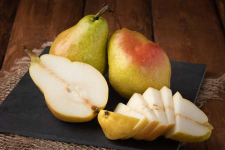 Eco fruit - fresh pear on wooden background, vegan foodの写真素材