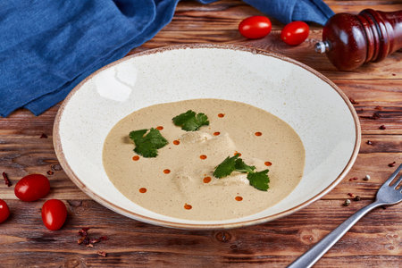 Chicken cream soup Satsivi in nut sauce, georgian cuisine, wooden backgroundの写真素材