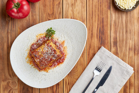 Lasagna bolognese, top view, wooden backgroundの写真素材