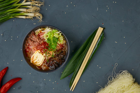 Sour spicy soup, chinese cuisine, concrete background