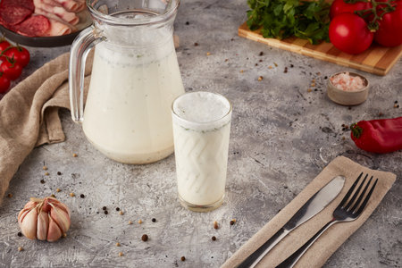 Sour milk drink with herbs, textured background