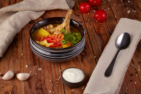 Hot soup with lamb, wooden backgroundの写真素材