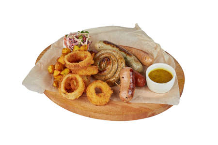 Grilled sausage with potatoes fries and bell peppers, ketchup, on white plate, isolated on white backgroundの写真素材