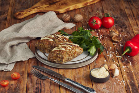 Fried minced meat (meat cutlet) on a plate, wooden backgroundの写真素材