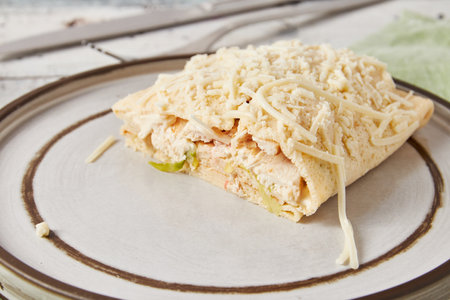 Crepes stuffed with Caesar salad, chicken, tomatoes, cheese and lettuce, closeupの写真素材