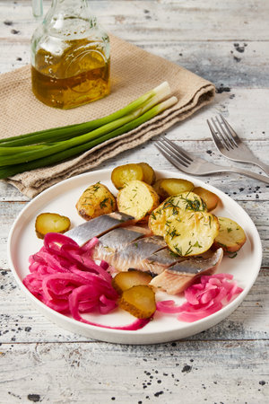 Herring with baked potato, onions and pickled cucumberの写真素材