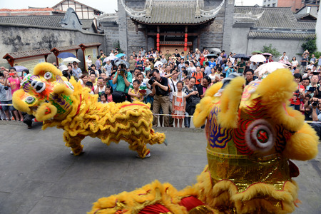 Tourists enjoying the dancing lions performanceのeditorial素材