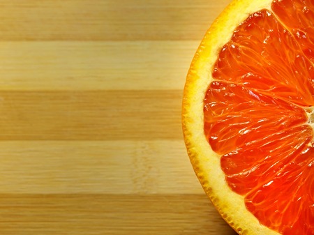 Delicious juicy orange red cut light crust beautiful texture backgroundの写真素材