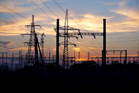 Energy. Supports high electricity against the sunset. Station transformation of electrical energy.