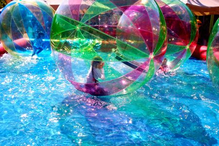 Happiness and fun, entertainment for children. A child in an inflatable floating balloon.の写真素材