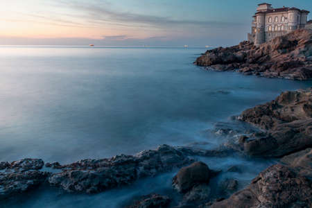 Boccale castle landmark on cliff rock and sea on warm sunset.のeditorial素材