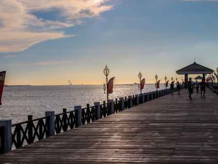 people walking on the wooden plank under the sunsetのeditorial素材