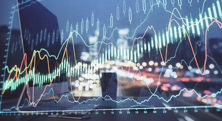 Forex graph hologram on table with computer background. Double exposure. Concept of financial markets.の素材
