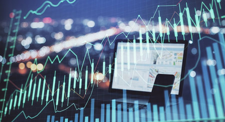 Laptop with abstract forex chart on blurry city background. Trade and finance concept. Double exposureの素材
