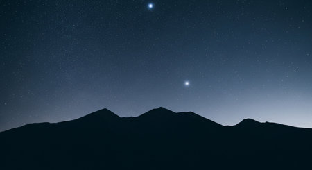 Night starry sky with stars and silhouette of a mountain range.の素材