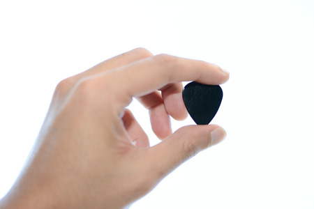 Guitar pick in hand.の写真素材