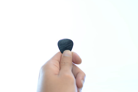 Guitar pick in hand.の写真素材
