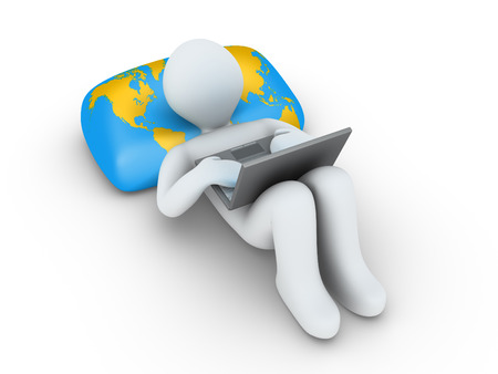 3d person using a laptop is lying on a pillow with the world mapの写真素材