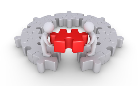 Two people are putting the last puzzle piece of a round puzzleの写真素材