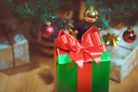 Christmas presents under a Christmas tree with defocused lightsの写真素材
