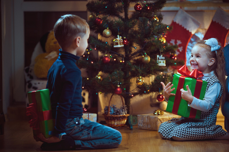 Happy children with Christmas gift, joy.の写真素材