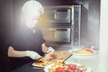 Chef prepares the ingredients for pizzaの写真素材