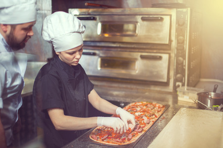 Chef prepares the ingredients for pizzaの写真素材