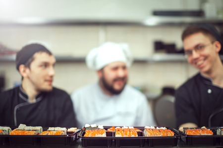 male cooks preparing sushi in the restaurant kitchen.の写真素材