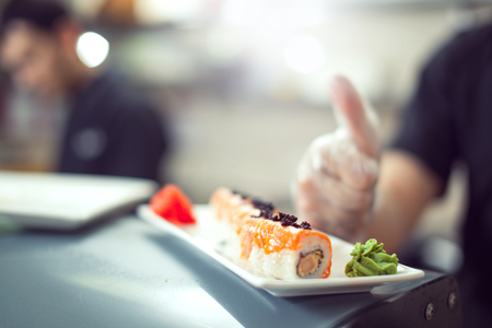 male cooks preparing sushi in the restaurant kitchen.の写真素材