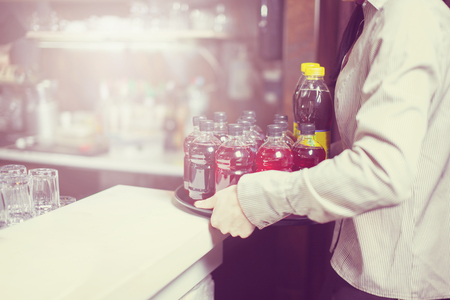 Waitress holding a drish with drinks at some festive event, party or wedding reception.の写真素材