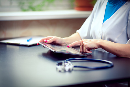 Woman doctor using tablet computer in hospitalの写真素材