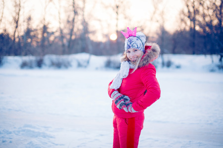 Family having fun at the outdoor skating rink in winter.の写真素材
