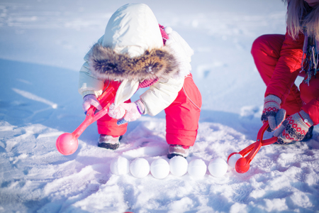 Children play outdoors in snow.Outdoor fun for family Christmas vacation.の写真素材