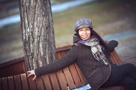 Beautiful young modern woman smiling happy and cheerful in trench coat.の写真素材