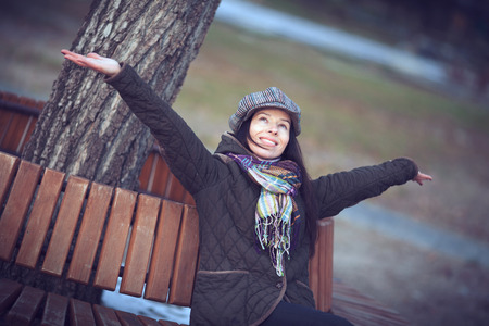 Beautiful young modern woman smiling happy and cheerful in trench coat.の写真素材