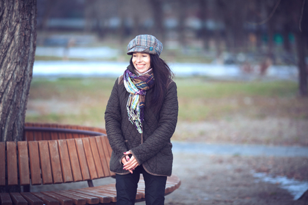 Beautiful young modern woman smiling happy and cheerful in trench coat.の写真素材