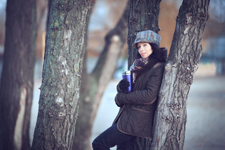 Beautiful young modern woman smiling happy and cheerful in trench coat.の写真素材