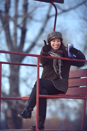 Beautiful young modern woman smiling happy and cheerful in trench coat.の写真素材