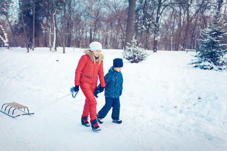 Mother and son enjoying beautiful winter day outdoorsの写真素材