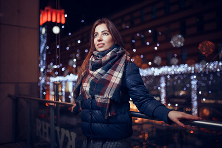 gorgeous brunette girl, portrait in night city lightsの写真素材