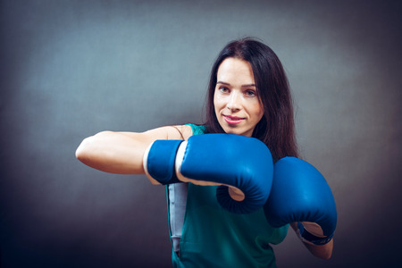 Young woman training punch boxing gloves