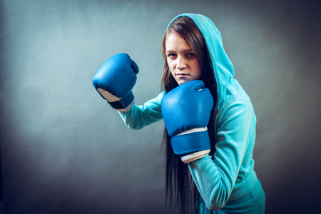 Young woman training punch boxing glovesの写真素材