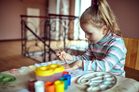 Children in nursery sitting at table drawing picturesの写真素材