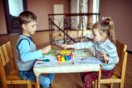 Children in nursery sitting at table drawing picturesの写真素材