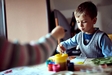 Children in nursery sitting at table drawing picturesの写真素材