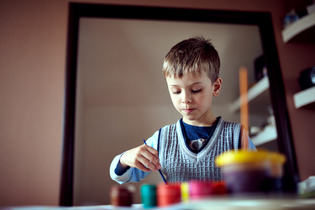 Children in nursery sitting at table drawing picturesの写真素材