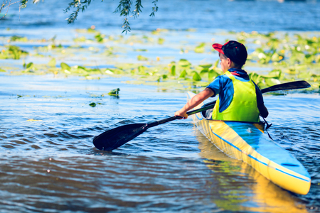 man paddling in kayak is on a river, kayakingの写真素材