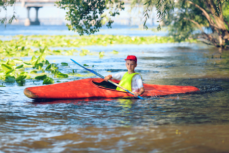 man paddling in kayak is on a river, kayakingの写真素材