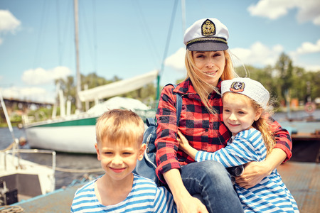 Family on the pier, against the background of yachts.の写真素材